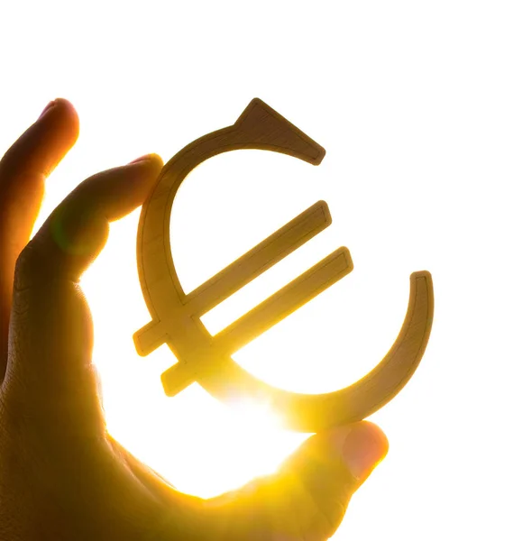Ręka Mężczyzny Holding Euro Ikona Sylwetka Przeciwko Zachód Słońca — Zdjęcie stockowe