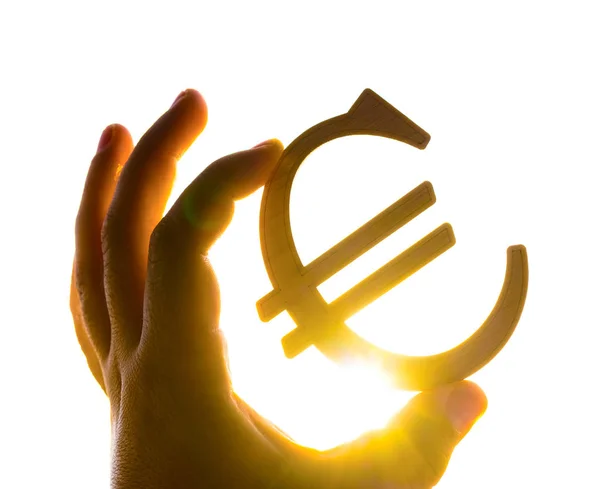 Ręka Mężczyzny Holding Euro Ikona Sylwetka Przeciwko Zachód Słońca — Zdjęcie stockowe
