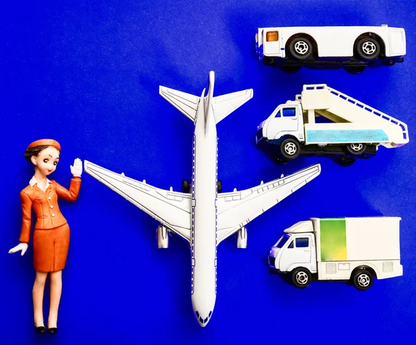 plane, stewardess, truck with baggage and aircraft gangway on blue paper background