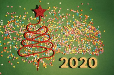 Sigh symbol Christmas Tree from a lot colorful confetti, lace and candy star toy 