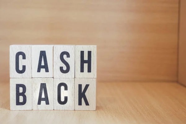 Letter blocks in word cash back on wood background. wooden background. Phrase cash back