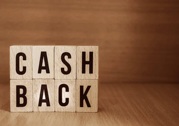 Letter blocks in word cash back on wood background. wooden background. Phrase cash back