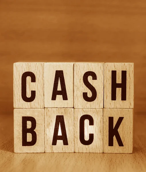 Letter blocks in word cash back on wood background. wooden background. Phrase cash back