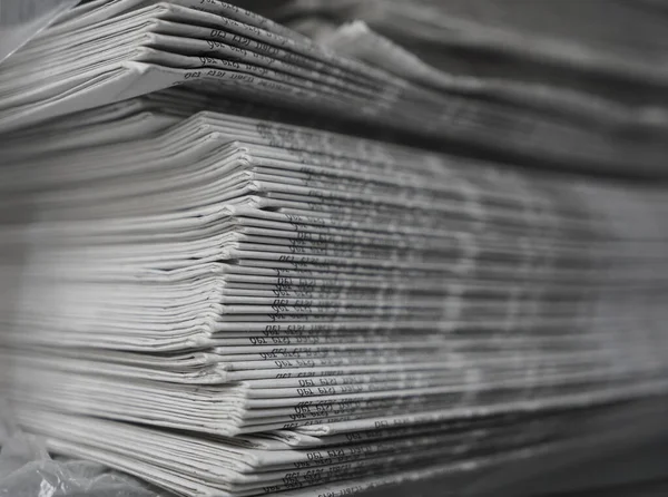 Pile of newspapers, background texture. retro journals with headlines, articles