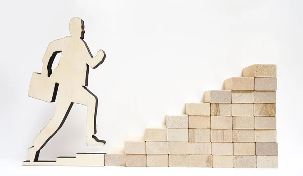 Business Steps. symbol with wood symbol. Growth concept. Man wooden figure   running up on stairs. Businessman figure. finance and money background. man with briefcase, stairway, euro figure isolated on a white background