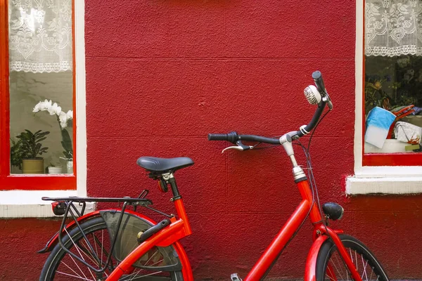 Röd Cykel Parkerad Utanför Ett Radhus Mellan Två Fönster — Stockfoto