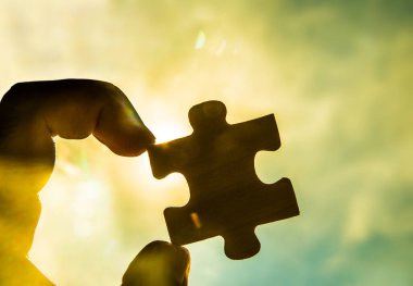 Gün batımı arkaplanı olan çift yapboz parçasını bağlamaya çalışıyorum.