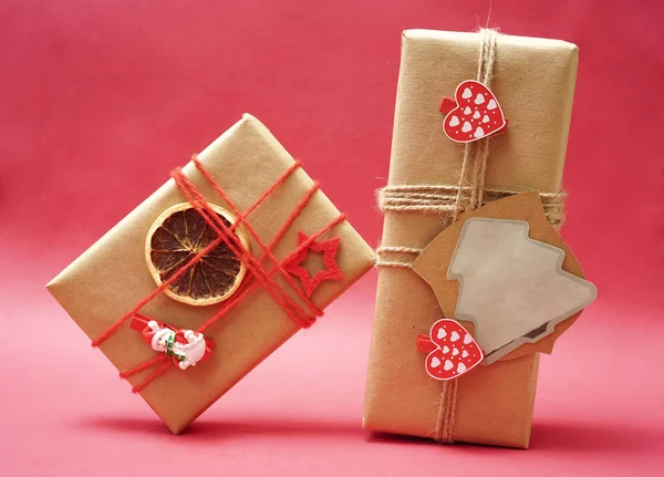 gift packages with pins on a red paper background. empty copy space for inscription.