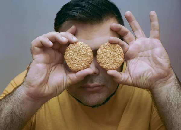 Happy Adult Bearded Man Holds Two Cookies Shape Front His — ストック写真