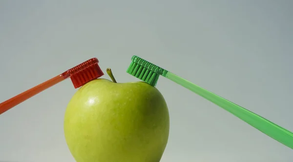 Pair Toothbrushes Stuck Green Apple Isolated White Gray Background Two — Stok fotoğraf