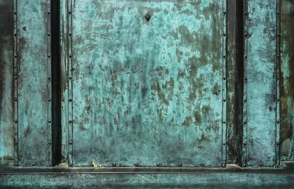 Bronze texture of old metal surface green background. Metal plate with green corrosion, texture of copper old plate