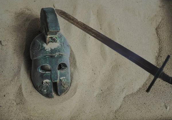 helmet of ancient warriors on sand background. Roman or ancient  greece Legionar. empty copy space for inscription.