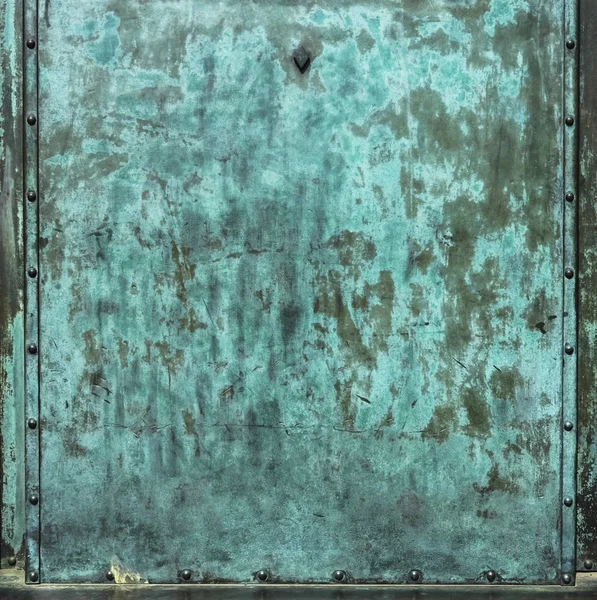 Bronze texture of old metal surface green background. Metal plate with green corrosion, texture of copper old plate