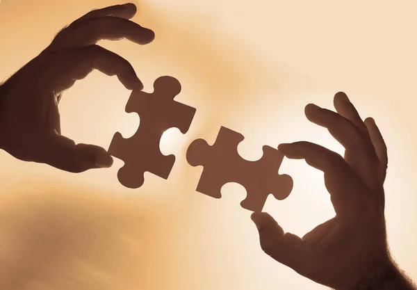hands  with  puzzle pieces. teamwork concept