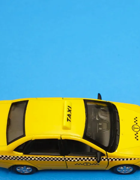 yellow taxi car - top view . Transport sign, auto, drive and symbol. blue background. empty copy space for inscription.