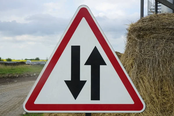 image photo of triangle traffic sign for two way.Two-way traffic sign with red triangle.