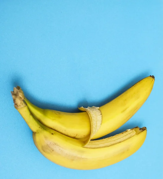 two bananas isolated on blue background. Love and tenderness. sign, symbol, concept of embracing couple