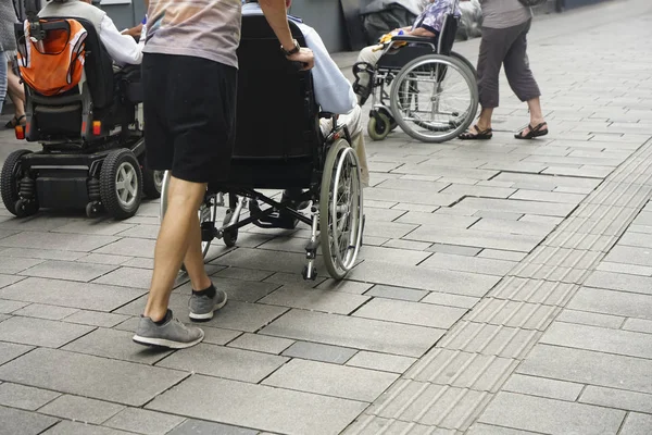 Close View Feet Person Pushing Wheelchair Paving Stoned Street Son — Stock Photo, Image