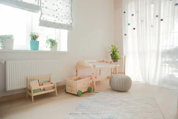 children\'s room and furniture and natural green flowers