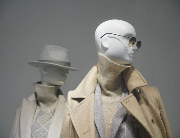Two female mannequins wear luxury style winter clothes. Female mannequins in shop window. Standing women dummies show casual style collection of clothes in showcase
