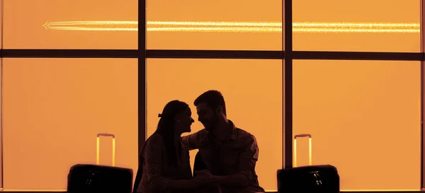 silhouette of young loving couple in  airport