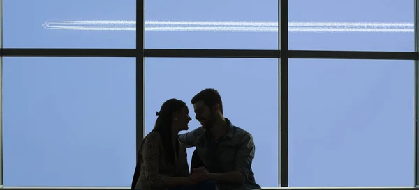 silhouette of young loving couple in  airport