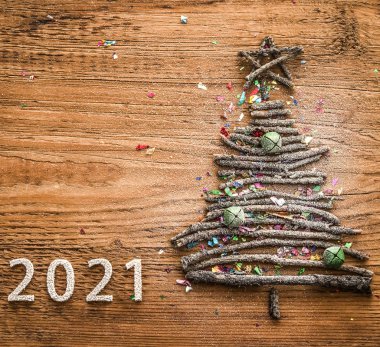 tree  from many dry Stick snowy Christmas. Wood star, bell toys on old retro vintage style wooden texture background. happy new year 2021  holiday