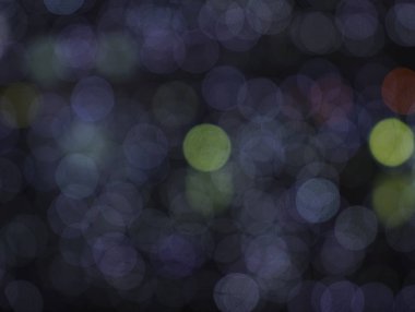 Abstract blurred background with rows of round, radiant multicolored lights. Abstract Night City Background. Colorful Bokeh. happy new year backgrop. 