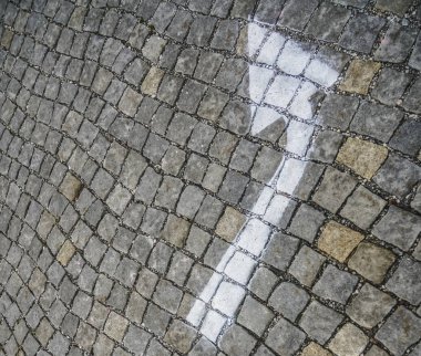 Beyaz ok eski eski kaldırım taşlarına boyanmış.. 