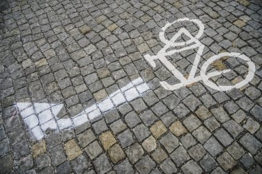Sokakta bisiklet yolu var. Bisiklet ve hareket işaretli yol taşı fayans şeridi. resim oku