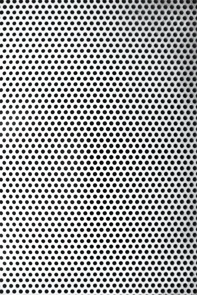 white and black pattern of iron background with many holes. metal mesh background.