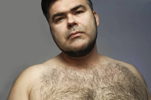 Closeup portrait of a hairy man. hairy body of a man. chest, excessive hairiness, depilation. tight build. fat body.