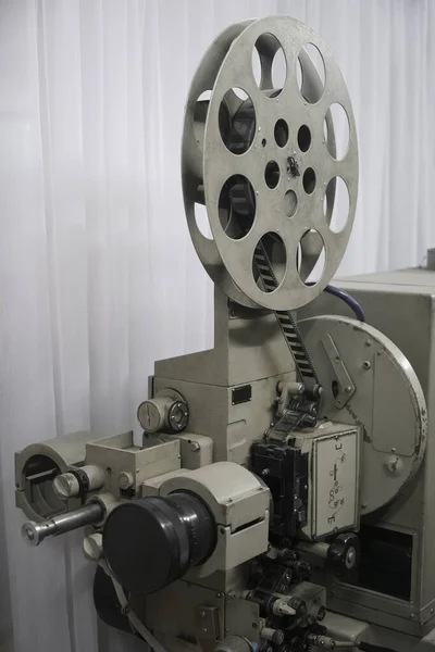 vintage projector turned on. The light exiting the lens. Rare industrial cinema 35 mm movie printer detail vintage black and white, analog optical process with rgb lamps and reels in post production factory