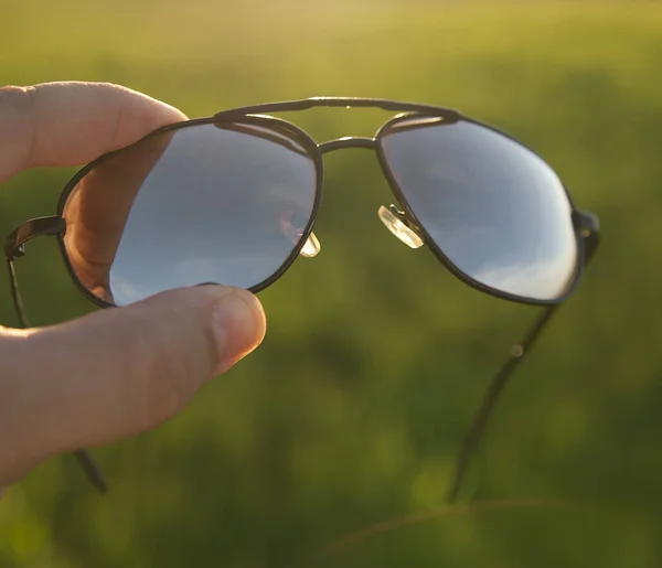 Male Hand Holding Sunglasses Fresh Green Grass — Stock Photo, Image