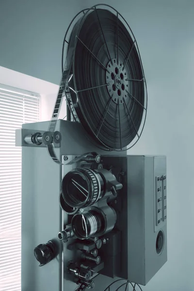 old 16mm or 35mm Film Projector isolated on gray wall background.vintage classic film projector with vintage color style. Old vintage rolling film projector with copy space for background