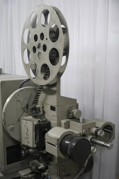 vintage projector turned on. The light exiting the lens. Rare industrial cinema 35 mm movie printer detail vintage black and white, analog optical process with rgb lamps and reels in post production factory