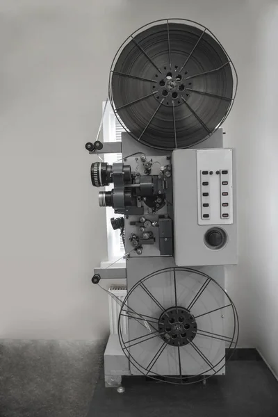 old 8mm Film Projector isolated on gray wall background.vintage classic film projector with vintage color style. Old vintage rolling film projector with copy space for background.