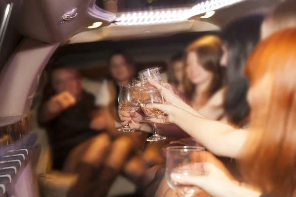 hen-party. girlfriend team night party. beautiful women clinking glasses inside limousine interior