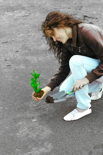 young woman with green pant. Concept of environmental conservation Complete. Planting plant to reduce global warming.