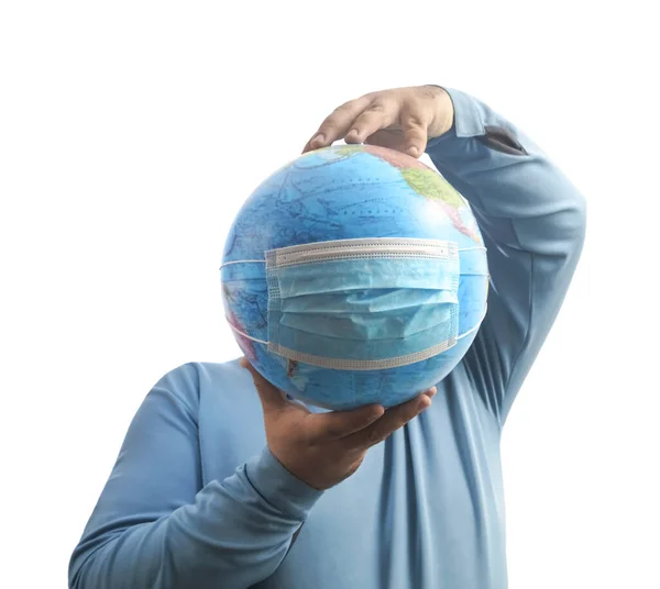 World Epidemic Danger. World need protect the earth globe with a face mask and hands, isolated on a white background. Human Epidemic Danger. globe map with virus mask behind male face