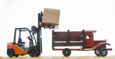 Forklift kargoyu depodan kamyona yüklüyor. Beyaz arka planda izole edilmiş. Karton kargo kutuları beyaz üzerine izole edilmiş standart küçük motor kamyon kaldırma