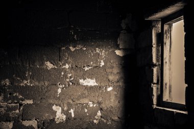 İnşaat halindeki bir binanın havalandırmalı beton bloklarından oluşan bir duvar. Duvardaki bir pencereden yansıyan ışıkla birlikte. Ev duvarlarının yapım aşamalarının arka planı, beyaz tuğlaların dokusu