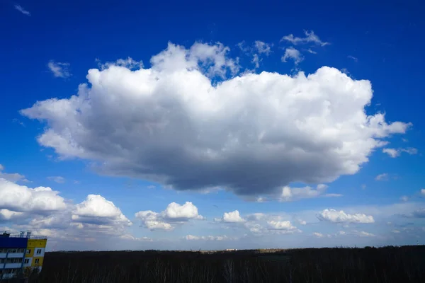 blue sky with big clouds. beautiful sky as a postcard. large fluffy white clouds in blue sky