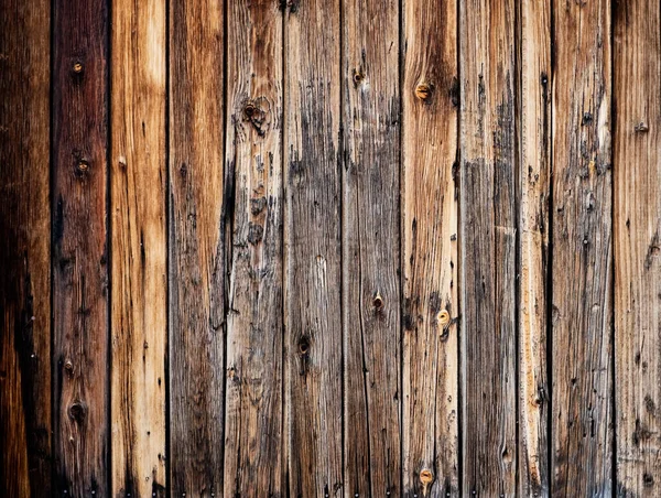 Old vintage outdoor wood with rusted screw texture in vertical line flooring background. Old brown wooden planks background.
