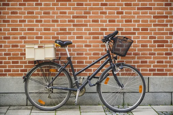 Classic view of Bike and wall. side view. Retro bicycle on roadside with vintage brick wall background.