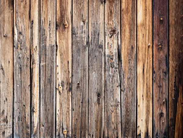 Old vintage outdoor wood with rusted screw texture in vertical line flooring background. Old brown wooden planks background.