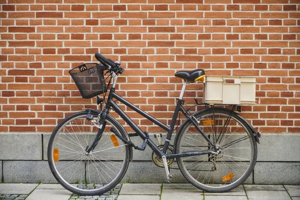 Classic view of Bike and wall. side view. Retro bicycle on roadside with vintage brick wall background.