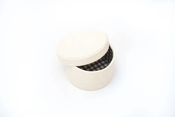 Round gift box with ajar lid on a white isolated background — 图库照片