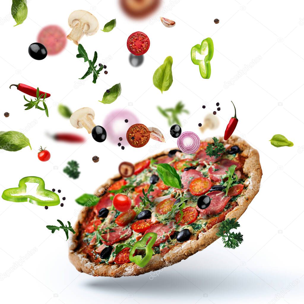 Flying pizza with ingredients colorful background vegetables meat basil oregano olive hot