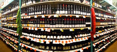 Red wine aisle in a Bottle King store clipart
